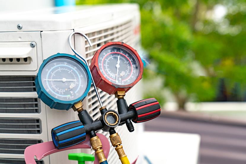 blue and red gauges used to check air conditioner